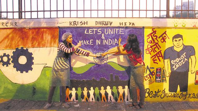Students paint a wall opposite St Xavier’s College in Mumbai. (Bhushan Koyande)