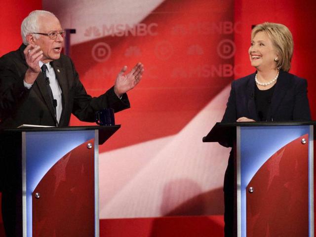 Democratic presidential candidate Hillary Clinton smiles as her rival Senator Bernie Sanders answers a question during a primary debate. (AP) Democratic presidential candidate Hillary Clinton smiles as her rival Senator Bernie Sanders answers a question during a primary debate. (AP)