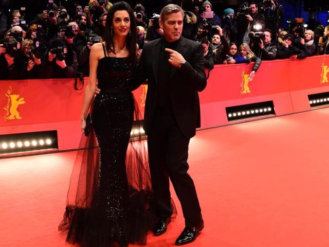 Even George Clooney seems to be aware of his wife’s superstar status. (AFP)