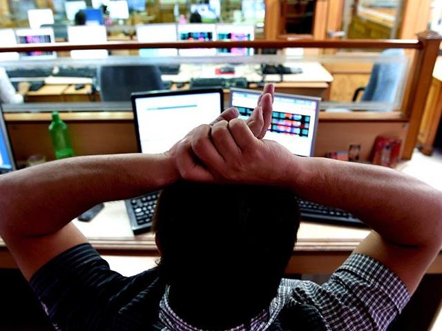 A stock dealer watches share prices on his screen at a brokerage house in Mumbai. (PTI File Photo) A stock dealer watches share prices on his screen at a brokerage house in Mumbai. (PTI File Photo)