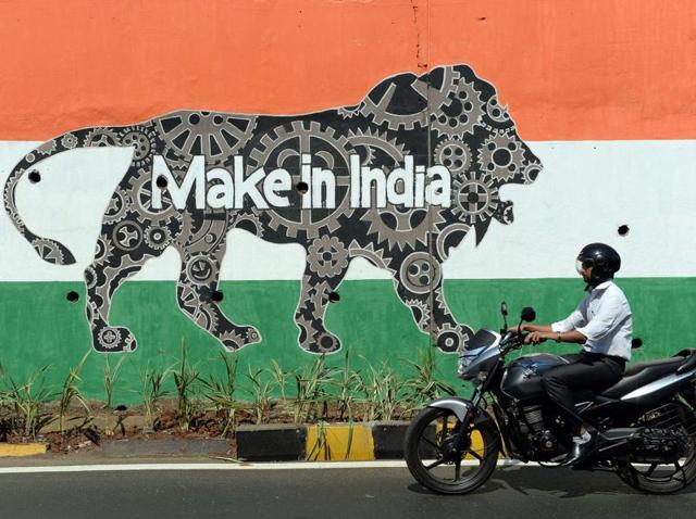 A motorist rides past a wall bearing the image of the mascot for the 'Make in India Week' in Mumbai. Over 10,000 security personnel have been deployed for PM Modi’s visit to the financial capital. (AFP Photo) A motorist rides past a wall bearing the image of the mascot for the 'Make in India Week' in Mumbai. Over 10,000 security personnel have been deployed for PM Modi’s visit to the financial capital. (AFP Photo)