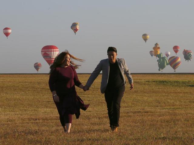 A couple holds hands with hot air balloons in the background in Manila, Philippines on the eve of Valentine’s Day on February 13, 2016. Twenty eight balloonists from USA, United Kingdom, Germany, France, Sweden, Japan, Thailand, Dominican Republic, Slovakia, The Netherlands, Ireland and the Philippines took part in the annual tourism festival that attracted thousands of tourists. (AP)
