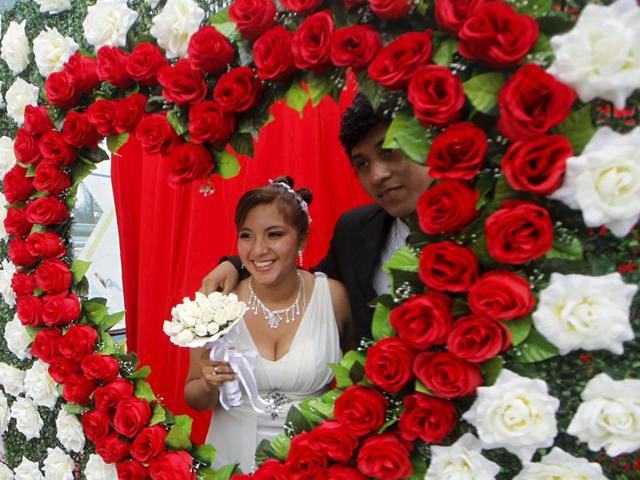 A couple poses for a picture after a mass wedding ceremony ahead of Valentine’s Day celebrations in Lima, Peru, February 12, 2016. 67 couples tied the knot in a mass wedding sponsored by the mayor of Chorrillos district. (REUTERS)