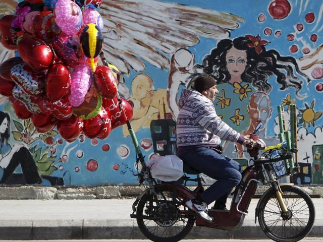 A street vendor sells heart-shaped balloons as he rides a motorbike ahead of Valentine’s Day in Sidon, southern Lebanon February 12, 2016. (REUTERS)