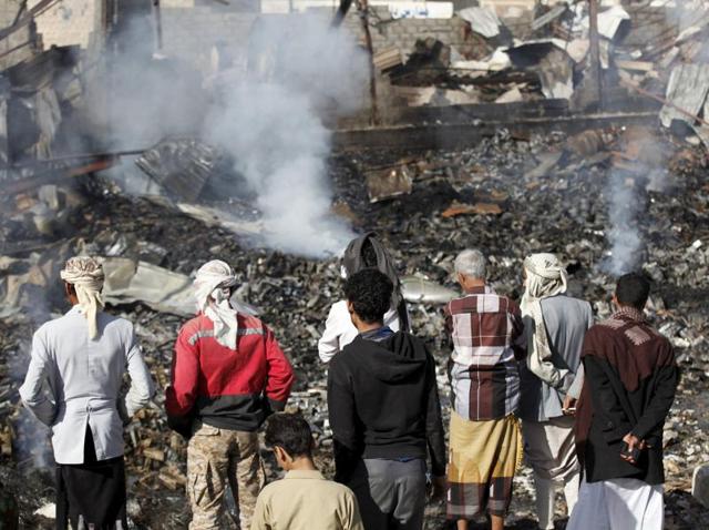 People look at the rubble of an electronics warehouse store after a Saudi-led air strike destroyed it in Yemen's capital Sanaa(REUTERS)