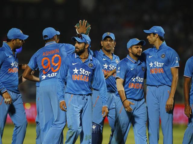 India's captain Mahendra Singh Dhoni, center, celebrates with teammates at the end of first innings of their third Twenty20 cricket match against Sri Lanka. (AP) 
