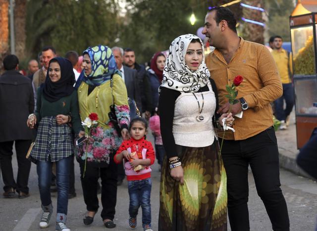 Iraqis hold Valentine's Day gifts at Zawra Park in Baghdad. (AP) Iraqis hold Valentine's Day gifts at Zawra Park in Baghdad. (AP)