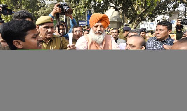 Delhi BJP MLA OP Sharma and his supporters seen escorting a man out of Patiala House Court. (Sonu Mehta/HT Photo) Delhi BJP MLA OP Sharma and his supporters seen escorting a man out of Patiala House Court. (Sonu Mehta/HT Photo)