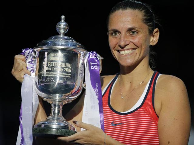 Winner Roberta Vinci of Italy, right, and runner-up Belinda Bencic of Switzerland, celebrate with their trophies after the St. Petersburg Ladies Trophy final on February 14, 2016.(AP Photo)