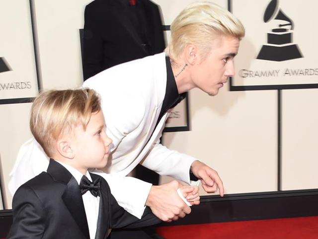 GOOD: Justin Bieber and his brother Jaxon raced on the Grammys red carpet. We don’t know who won but for the sheer moment and Justin’s facial fuzz, we like. (AFP) 