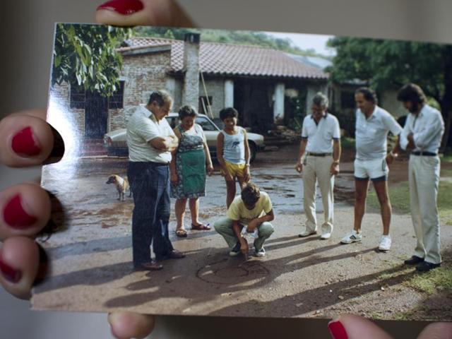 In this Feb. 13, 2016 photo, Luz Mary Lopez, director of the Capilla del Monte Center of UFO Investigation, shows a 1986 picture in which 12-year-old Gabriel Gomez draws in the sand, for local authorities, a representation of the UFO he saw from his window on Jan. 9, 1986 in Capilla del Monte, Cordoba, Argentina. Lopez's late husband made the investigation of the townís UFO sightings his lifeís work, and she has continued this by offering detailed talks on the mysterious events. (AP Photo/Natacha Pisarenko) (AP) In this Feb. 13, 2016 photo, Luz Mary Lopez, director of the Capilla del Monte Center of UFO Investigation, shows a 1986 picture in which 12-year-old Gabriel Gomez draws in the sand, for local authorities, a representation of the UFO he saw from his window on Jan. 9, 1986 in Capilla del Monte, Cordoba, Argentina. Lopez's late husband made the investigation of the townís UFO sightings his lifeís work, and she has continued this by offering detailed talks on the mysterious events. (AP Photo/Natacha Pisarenko) (AP)
