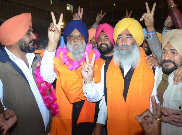 SAD candidate Ravinder Singh Brahmpura and his father and MP Ranjeet Singh Brahmpura showing victory sign after winning the Khadoor Sahib by-elections on Tuesday.(Sameer Sehgal/ HT)