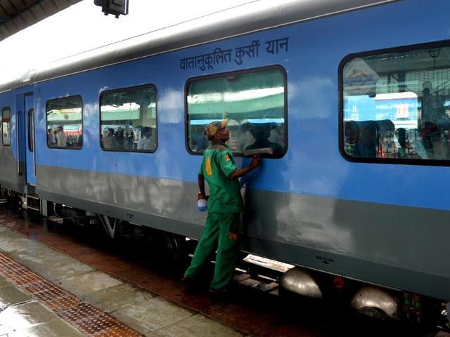 An Indian railways worker cleans a coach prior to the trial run of a high-speed train between New Delhi and Agra is flagged off at New Delhi railway station. (AFP Photo) An Indian railways worker cleans a coach prior to the trial run of a high-speed train between New Delhi and Agra is flagged off at New Delhi railway station. (AFP Photo)