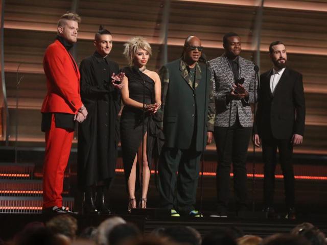 Stevie Wonder, center, and from left Scott Hoying, Mitch Grassing, Kristin Maldonado, Kevin Olusola, and Avi Kaplan of Pentatonix perform at the 58th annual Grammy Awards.  (Matt Sayles/Invision/AP) 