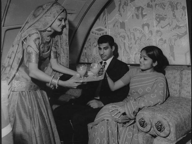 An in-flight photograph showing Air India's air hostess in the spacious Maharajah lounge inside a Boeing 747. The scenes from ‘Jatak kathas’ form the background. (HT Archives)