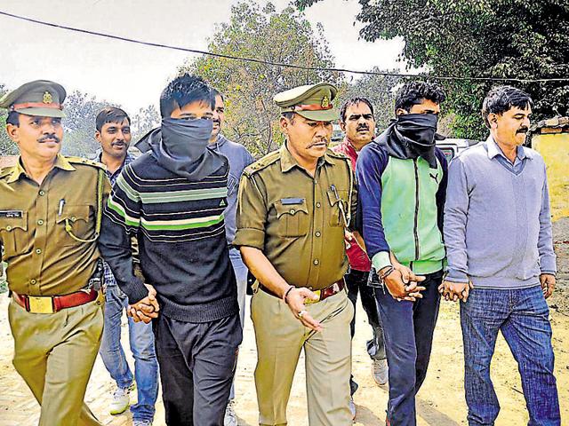 Prime accused Devendra (second from right) and his accomplice in police custody on Tuesday. (HT Photo) Prime accused Devendra (second from right) and his accomplice in police custody on Tuesday. (HT Photo)