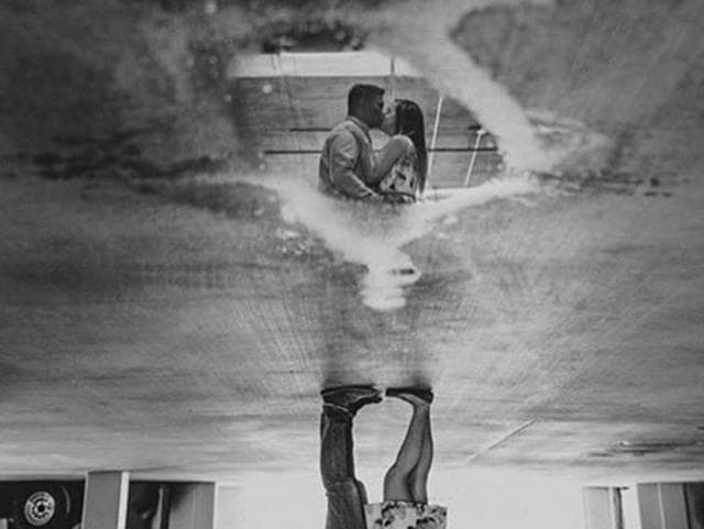 A picture posted by Californian photographer Ryan Horban. The couple is visible in the reflection  in water in this black and white upside-down picture. (Instagram/ryanhorban) 