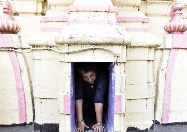 Path to enlightenment: The Shikhara (temple top) of Thakurdwar temple houses a Shivaling. A structure that symbolises the female reproductive system has a narrow entrance that one can crawl in (as shown in the picture). The interior is shaped like a dome, symbolising the universe. The Shivaling symbolises the union of man and woman. (Photo: Kunal Patil/ Hindustan Times) Path to enlightenment: The Shikhara (temple top) of Thakurdwar temple houses a Shivaling. A structure that symbolises the female reproductive system has a narrow entrance that one can crawl in (as shown in the picture). The interior is shaped like a dome, symbolising the universe. The Shivaling symbolises the union of man and woman. (Photo: Kunal Patil/ Hindustan Times)