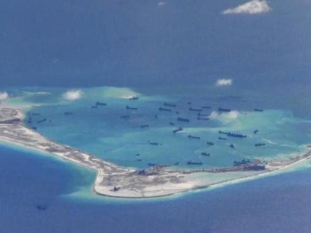 Chinese dredging vessels are purportedly seen in the waters around Mischief Reef in the disputed Spratly Islands in the South China Sea in this still image from video taken by a P-8A Poseidon surveillance aircraft provided by the United States Navy.(US Navy Handout Image) Chinese dredging vessels are purportedly seen in the waters around Mischief Reef in the disputed Spratly Islands in the South China Sea in this still image from video taken by a P-8A Poseidon surveillance aircraft provided by the United States Navy.(US Navy Handout Image)