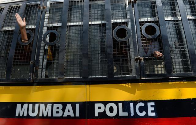 Students shout slogans from inside a police van after courting arrest during a protest to condemn students actions in New Delhi, in Mumbai. (AFP)
