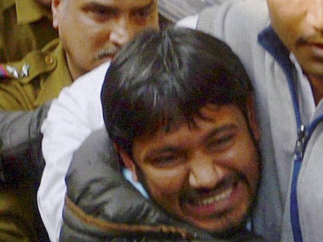 Kanhaiya Kumar (C), head of the student union at Delhi's Jawaharlal Nehru University (JNU), is escorted by police outside the Patiala House court in New Delhi