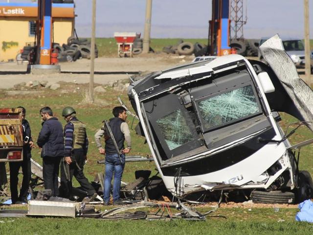 Members of Turkish forces gather around a bus that was destroyed in an explosion on the road linking the cities of Diyarbakir and Bingol, in south eastern Turkey. (AP Photo) Members of Turkish forces gather around a bus that was destroyed in an explosion on the road linking the cities of Diyarbakir and Bingol, in south eastern Turkey. (AP Photo)