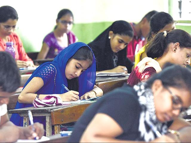 Students at Shivaji Sikshan Santha Multipurpose Technical High School, Ghatkopar (E), get cracking on the English paper, which followed a new activity-based pattern.(Arijit Sen/HT photo)