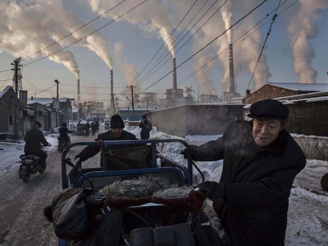 Chinese men pull a tricycle in a neighborhood next to a coal-fired power plant in Shanxi November 26, 2015. A history of heavy dependence on burning coal for energy has made China the source of nearly a third of the world's total carbon dioxide (CO2) emissions, the toxic pollutants widely cited by scientists and environmentalists as the primary cause of global warming. (Kevin Frayer/ REUTERS) Chinese men pull a tricycle in a neighborhood next to a coal-fired power plant in Shanxi November 26, 2015. A history of heavy dependence on burning coal for energy has made China the source of nearly a third of the world's total carbon dioxide (CO2) emissions, the toxic pollutants widely cited by scientists and environmentalists as the primary cause of global warming. (Kevin Frayer/ REUTERS)