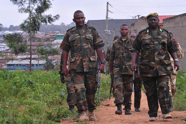 Kenya Wildlife Service (KWS) officers carrying tranquilizer guns, take part in a search of lions. (AFP)
