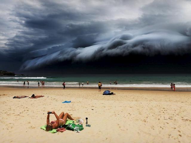 Nature, 1st prize singles, World Press Photo Awards (Rohan Kelly - Storm Front on Bondi Beach)A sunbather is oblivious to the ominous shelf cloud approaching on Bondi beach November 6, 2015. A massive “cloud tsunami� looms over Sydney in a spectacular weather event seen only a few times a year. The enormous shelf cloud rolled in from the sea, turning the sky almost black and bringing violent thunderstorms in its wake. REUTERS/Rohan Kelly via WPP EDITORIAL USE ONLY. NO RESALES. NO ARCHIVE (REUTERS) Nature, 1st prize singles, World Press Photo Awards (Rohan Kelly - Storm Front on Bondi Beach)A sunbather is oblivious to the ominous shelf cloud approaching on Bondi beach November 6, 2015. A massive “cloud tsunami� looms over Sydney in a spectacular weather event seen only a few times a year. The enormous shelf cloud rolled in from the sea, turning the sky almost black and bringing violent thunderstorms in its wake. REUTERS/Rohan Kelly via WPP EDITORIAL USE ONLY. NO RESALES. NO ARCHIVE (REUTERS)