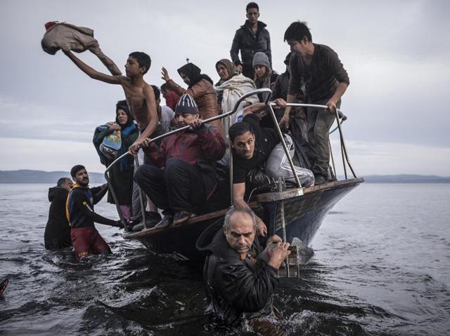 In this image released by World Press Photo titled ‘Reporting Europe's Refugee Crisis’ by photographer Sergey Ponomarev for The New York Times which won the first prize in the General News Stories category shows refugees arriving by boat near the village of Skala on Lesbos, Greece, 16 November 2015. (Sergey Ponomarev/ NYT/ AP) In this image released by World Press Photo titled ‘Reporting Europe's Refugee Crisis’ by photographer Sergey Ponomarev for The New York Times which won the first prize in the General News Stories category shows refugees arriving by boat near the village of Skala on Lesbos, Greece, 16 November 2015. (Sergey Ponomarev/ NYT/ AP)