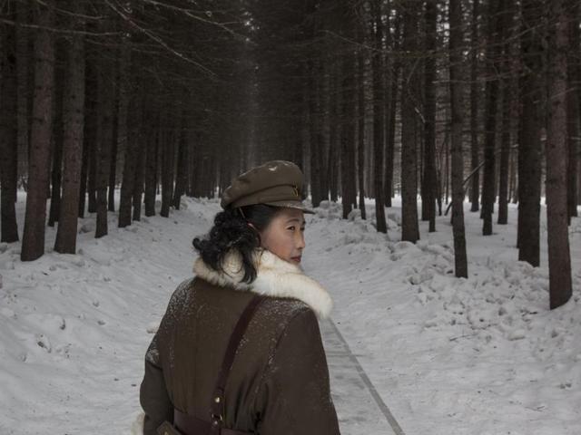 In this image released by World Press Photo titled ‘North Korea Life in the Cult of Kim’, by photographer David Guttenfelder, AP, which won a third prize in the Long term Projects category shows a North Korean soldier, working as a guide, walking through a forest April 4, 2012, that is said to be a former camp site where the late North Korean leader Kim Il Sung overnight while leading a battle against the Japanese at the foot of Mount Paektu, North Korea. (David Guttenfelder/ AP) In this image released by World Press Photo titled ‘North Korea Life in the Cult of Kim’, by photographer David Guttenfelder, AP, which won a third prize in the Long term Projects category shows a North Korean soldier, working as a guide, walking through a forest April 4, 2012, that is said to be a former camp site where the late North Korean leader Kim Il Sung overnight while leading a battle against the Japanese at the foot of Mount Paektu, North Korea. (David Guttenfelder/ AP)