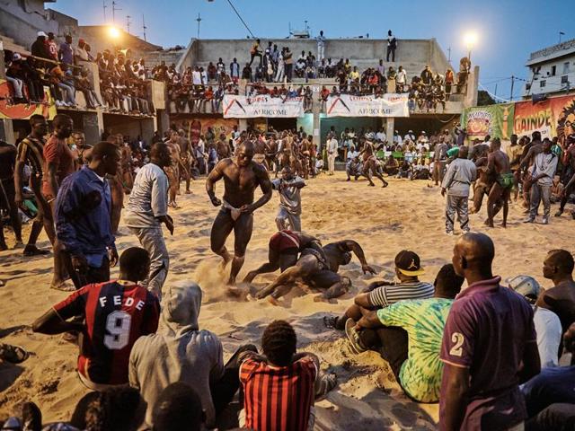 In this image released by World Press Photo titled "The Gris-gris Wrestlers of Senegal" by photographer Christian Bobst which won the second prize Sports Stories category shows a tournament in the Adrien Senghor arena leaning towards the end. The wrestling fights take place in the late evenings when temperatures drop. Dakar, Senegal, 28 March 28, 2015. (Christian Bobst, World Press Photo via AP) (AP) In this image released by World Press Photo titled "The Gris-gris Wrestlers of Senegal" by photographer Christian Bobst which won the second prize Sports Stories category shows a tournament in the Adrien Senghor arena leaning towards the end. The wrestling fights take place in the late evenings when temperatures drop. Dakar, Senegal, 28 March 28, 2015. (Christian Bobst, World Press Photo via AP) (AP)