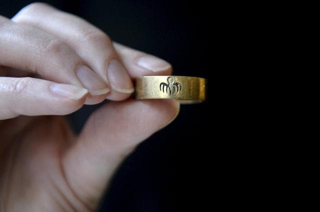 A worker holds a Spectre 9 carat gold ring made for the James Bond film Spectre during a media preview of "Spectre - the Auction", at Christie's auction house in London. (REUTERS) A worker holds a Spectre 9 carat gold ring made for the James Bond film Spectre during a media preview of "Spectre - the Auction", at Christie's auction house in London. (REUTERS)