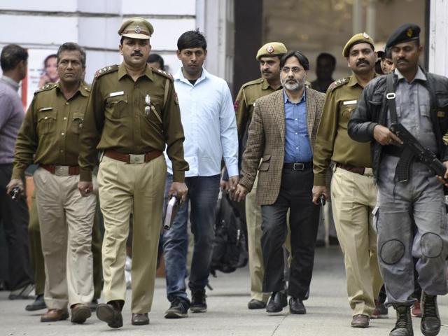 Delhi Police officers with SAR Geelani, former Delhi University lecturer, who was booked for sedition for allegedly organising an event marking the death anniversary of Parliament attack convict Afzal Guru at the Press Club of India. (Hindustan Times) Delhi Police officers with SAR Geelani, former Delhi University lecturer, who was booked for sedition for allegedly organising an event marking the death anniversary of Parliament attack convict Afzal Guru at the Press Club of India. (Hindustan Times)