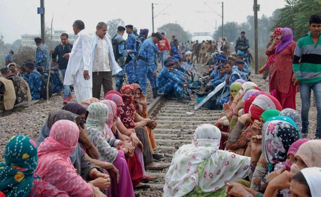 Jat protesters blocked the railway tracks during their agitation in Sonipat on Saturday. (PTI) Jat protesters blocked the railway tracks during their agitation in Sonipat on Saturday. (PTI)