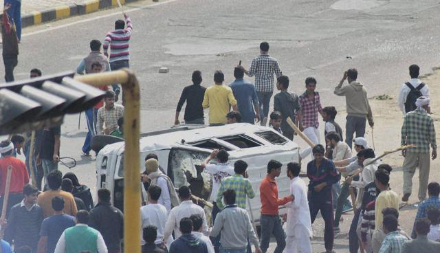 Jat protesters smashed a vehicle during their agitation in Rohtak on Friday. (PTI) Jat protesters smashed a vehicle during their agitation in Rohtak on Friday. (PTI)
