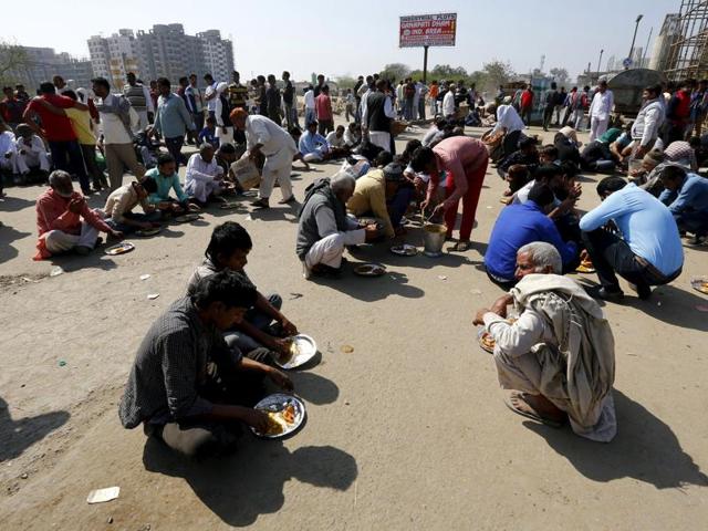Demonstrators from the Jat community eat as they block the Delhi-Haryana national highway during a protest in New Delh. Protesters converged on major crossroads and forced highway petrol pumps across the state to shut down, amid reports that the army was forced to back down in some areas. (REUTERS) 