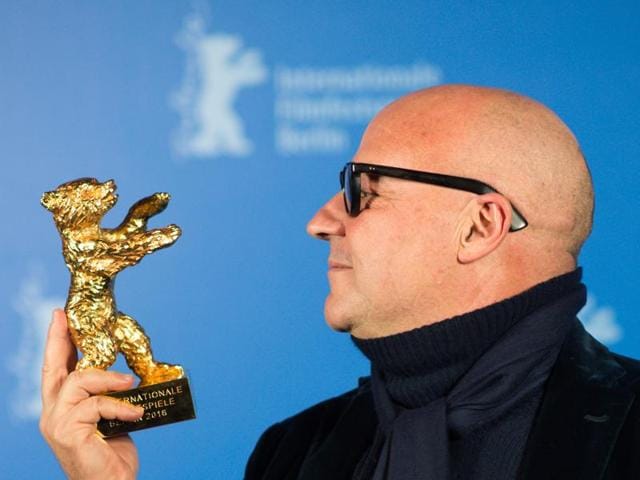 Gianfranco Rosi, director of Fuocoammare, looks at the Golden Bear for the Best Film during the award ceremony of the 2016 Berlin Film Festival Berlinale. (AP) Gianfranco Rosi, director of Fuocoammare, looks at the Golden Bear for the Best Film during the award ceremony of the 2016 Berlin Film Festival Berlinale. (AP)