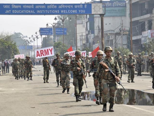 Indian army soldiers conduct a flag march at Rohtak.(AP Photo)