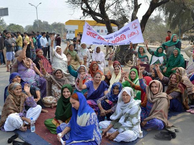 People of Jat community block the old Delhi road in Gurgaon during their agitation for reservation. Authorities clamped curfew in eight districts -- Rohtak, Bhiwani, Jhajjar, Hisar, Jind, Kaithal, Sonipat and Panipat - but angry mobs continued to run riot over large swathes of the state. (PTI) 