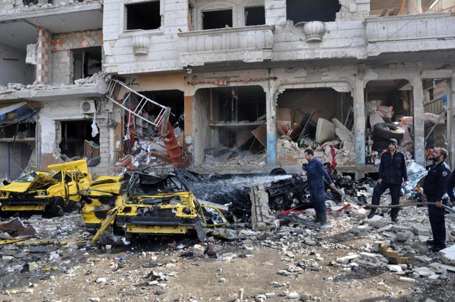 Syrian firefighters spray water on burning car at the site of a double car bomb attack in the Al-Zahraa neighborhood of the central Syrian city of Homs. (AFP Photo) Syrian firefighters spray water on burning car at the site of a double car bomb attack in the Al-Zahraa neighborhood of the central Syrian city of Homs. (AFP Photo)