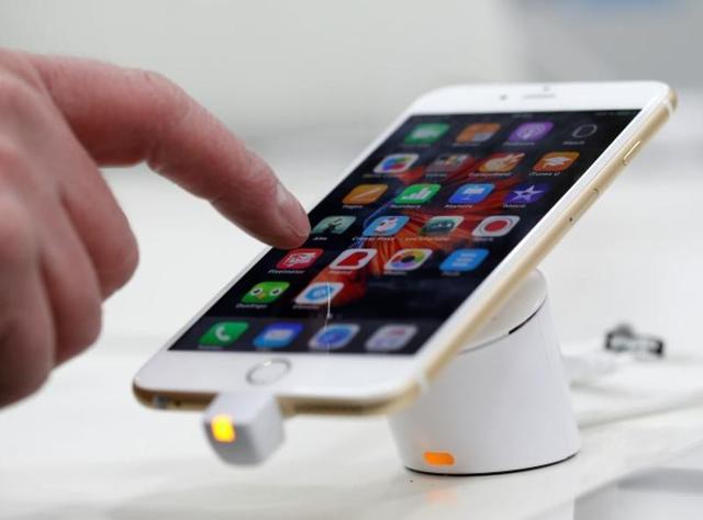 A woman uses her mobile phone, an iPhone 6 in Munich. Apple’s ongoing battle with the FBI over phone data encryption will set a global standard over how states can violate  personal phone data when it is deemed to be for national security reasons. (REUTERS)