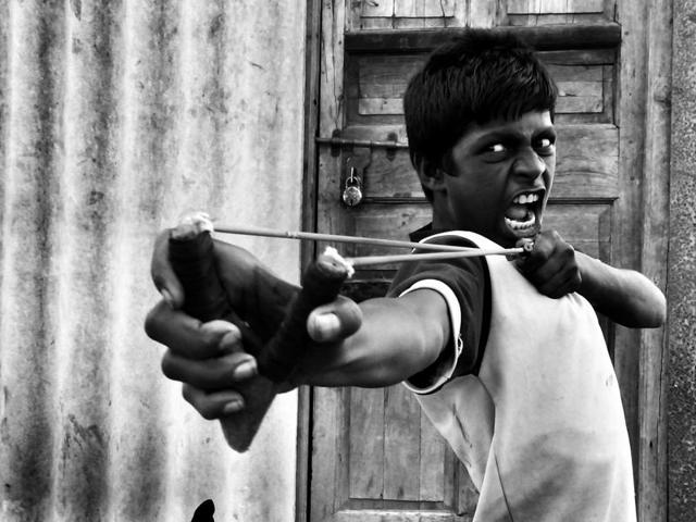 The photo, clicked in Mumbai, shows a teenager using his sling-shot to knock down a bottle after photographer Nikunj Rathod convinced a group of children to demonstrate their skills. (Nikunj Rathod/2016 Sony World Photography Awards) The photo, clicked in Mumbai, shows a teenager using his sling-shot to knock down a bottle after photographer Nikunj Rathod convinced a group of children to demonstrate their skills. (Nikunj Rathod/2016 Sony World Photography Awards)