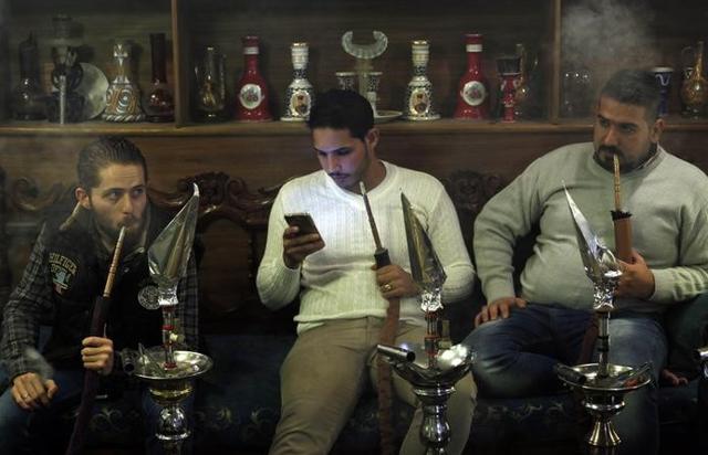 Men smoke shisha at a cafe in Baghdad. The city was named as the Worst City in the World. (Reuters) Men smoke shisha at a cafe in Baghdad. The city was named as the Worst City in the World. (Reuters)