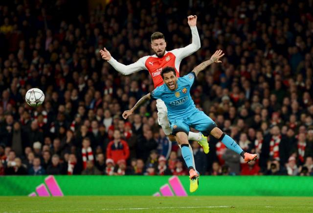 Barcelona's Dani Alves in action with Arsenal's Olivier Giroud. (REUTERS) Barcelona's Dani Alves in action with Arsenal's Olivier Giroud. (REUTERS)