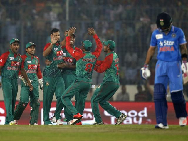 Bangladesh’s captain Mashrafe Mortaza, third left, celebrates with his teammates after the dismissal of India’s Virat Kohli, right. (AP Photo) Bangladesh’s captain Mashrafe Mortaza, third left, celebrates with his teammates after the dismissal of India’s Virat Kohli, right. (AP Photo)