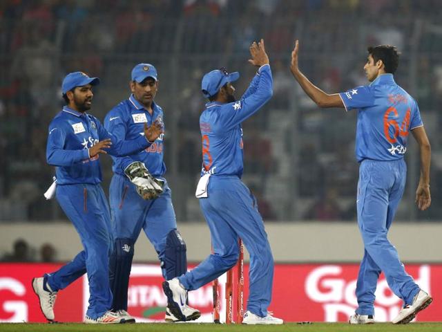 Nehra, right, celebrates with teammates after the dismissal of Mithun. (AP Photo) Nehra, right, celebrates with teammates after the dismissal of Mithun. (AP Photo)
