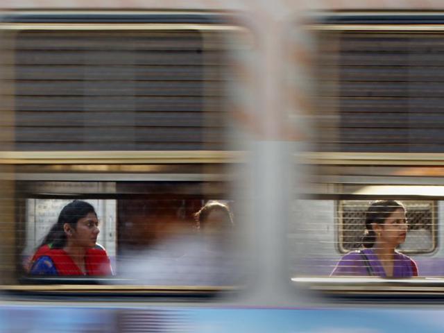 The other side:  Commuters inside a local train at Bandra station. (Satish Bate/HT Photo) 