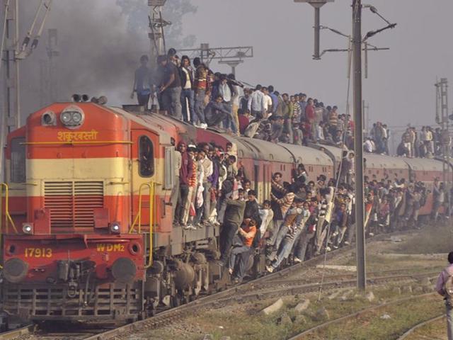 Ticket checker’s nightmare: Hundreds travel on the roof and hanging on the footboard of a train near Loni railway station in Ghaziabad .  (Sakib Ali/HT Photo) 